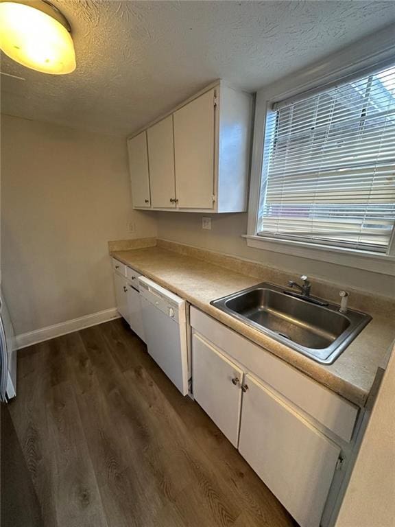 kitchen featuring a textured ceiling, white cabinetry, sink, and white dishwasher