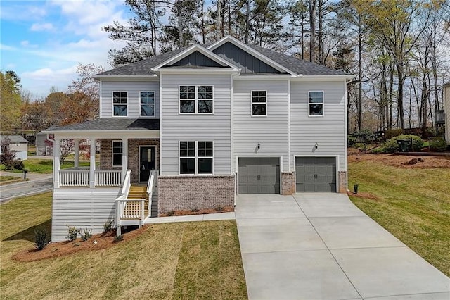 view of front of house with a front yard, a garage, and a porch