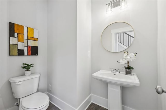 bathroom with hardwood / wood-style floors and toilet