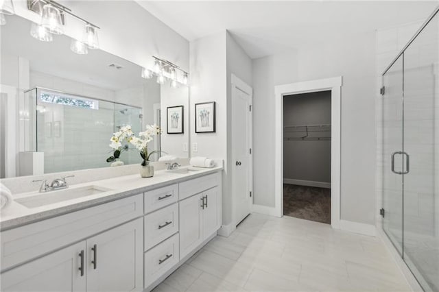 bathroom with a shower with door and vanity