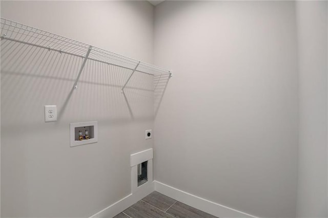 washroom featuring hookup for a washing machine, hookup for an electric dryer, and dark wood-type flooring