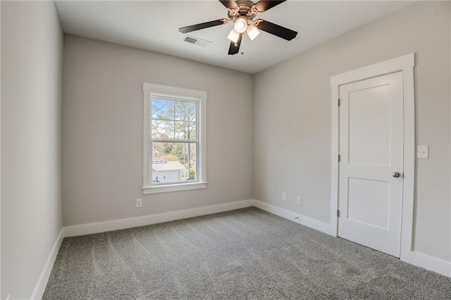 carpeted spare room featuring ceiling fan