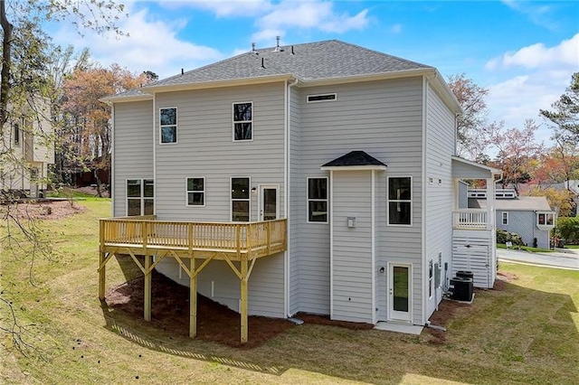 back of property featuring a lawn, central AC unit, and a deck