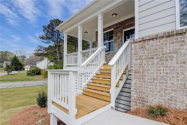 view of exterior entry featuring covered porch