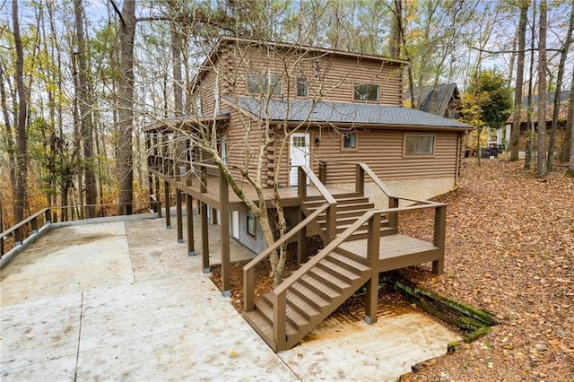 back of property with a wooden deck