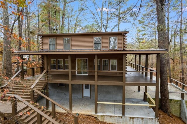 back of house with a wooden deck