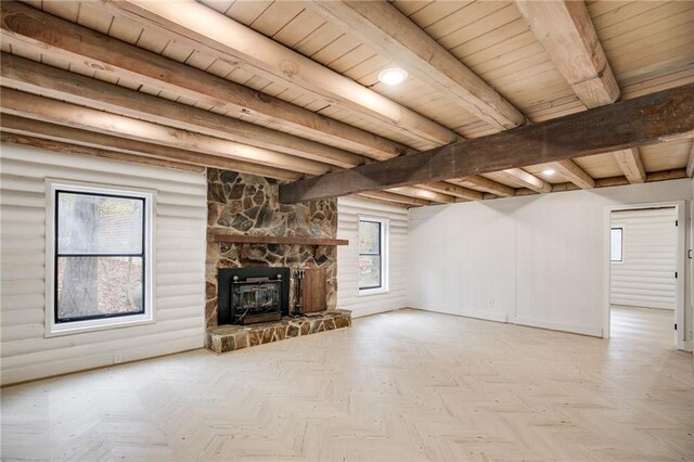 unfurnished living room featuring beamed ceiling, plenty of natural light, wooden ceiling, and light parquet floors