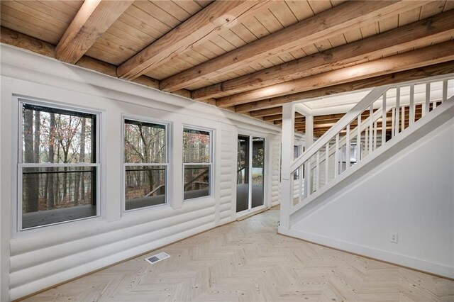 unfurnished sunroom with beamed ceiling and wooden ceiling