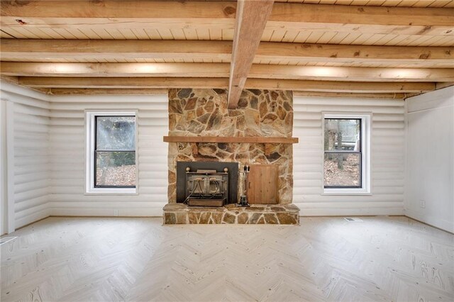 unfurnished living room with beamed ceiling, wooden ceiling, parquet floors, and a wood stove