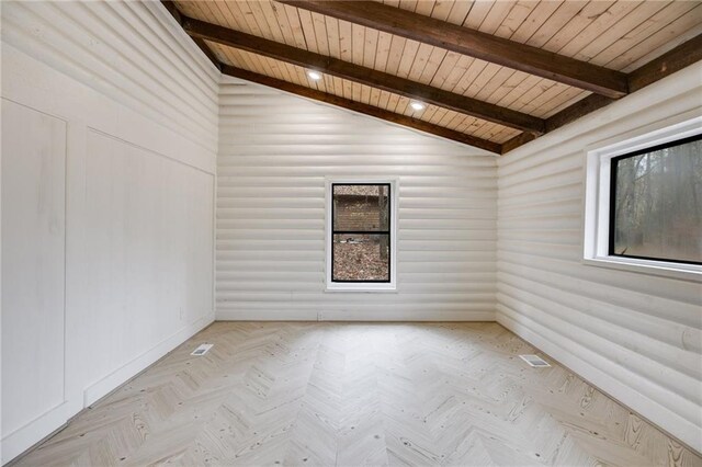 spare room with vaulted ceiling with beams, light parquet floors, and wood ceiling