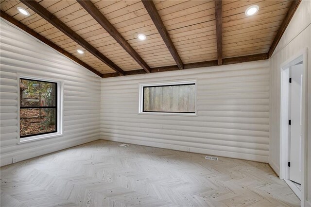 empty room with lofted ceiling with beams, light parquet flooring, and wood ceiling