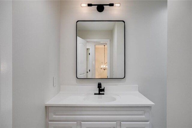 bathroom with vanity and a notable chandelier