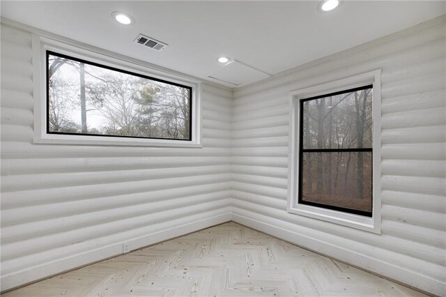 unfurnished room featuring light parquet flooring