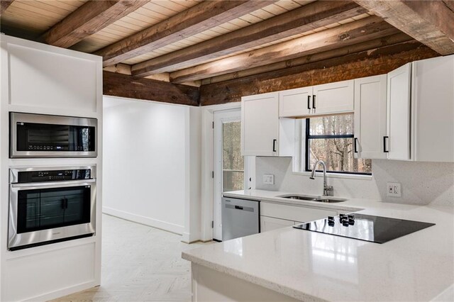 kitchen with wooden ceiling, white cabinets, sink, beamed ceiling, and stainless steel appliances