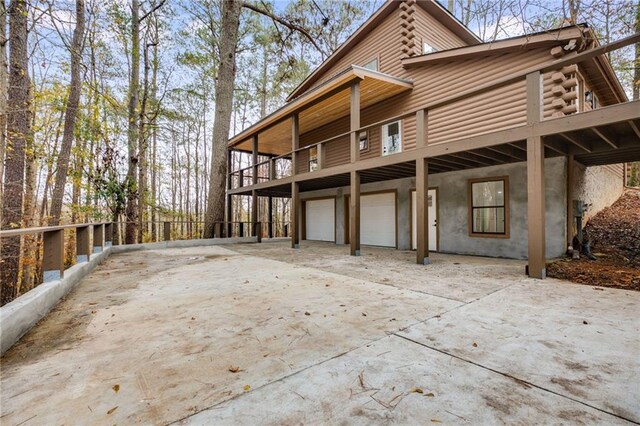 view of side of home with a garage and a balcony