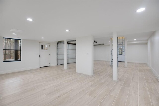 basement with light hardwood / wood-style floors