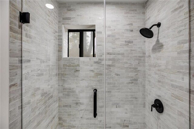 bathroom with a shower with door