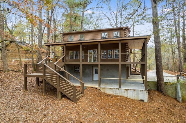 back of property featuring a wooden deck