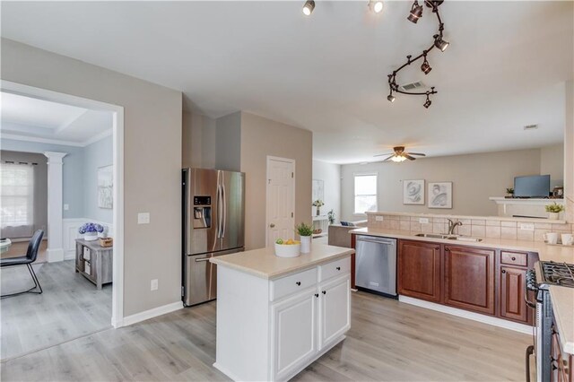4092 Duran Ln, Auburn, GA 30011 - kitchen with appliances with stainless steel finishes, light wood finished floors, light countertops, ceiling fan, and brown cabinetry