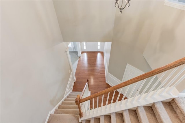 4092 Duran Ln, Auburn, GA 30011 - stairs with a towering ceiling, wood finished floors, and a chandelier