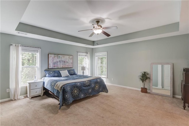 4092 Duran Ln, Auburn, GA 30011 - bedroom featuring a tray ceiling, carpet flooring, and multiple windows
