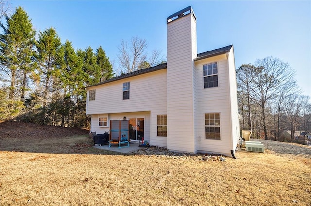 rear view of property featuring a patio area and a yard