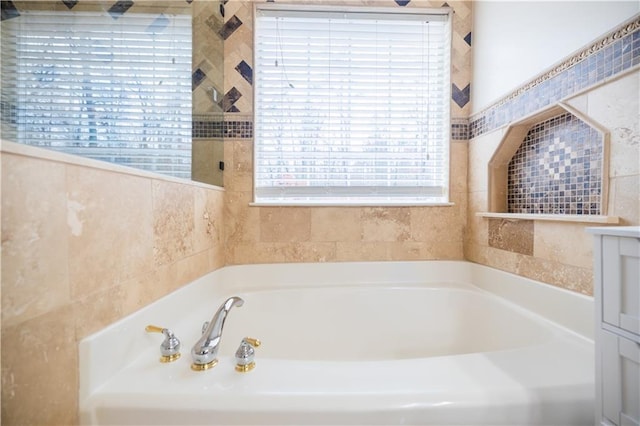 bathroom featuring vanity and a tub