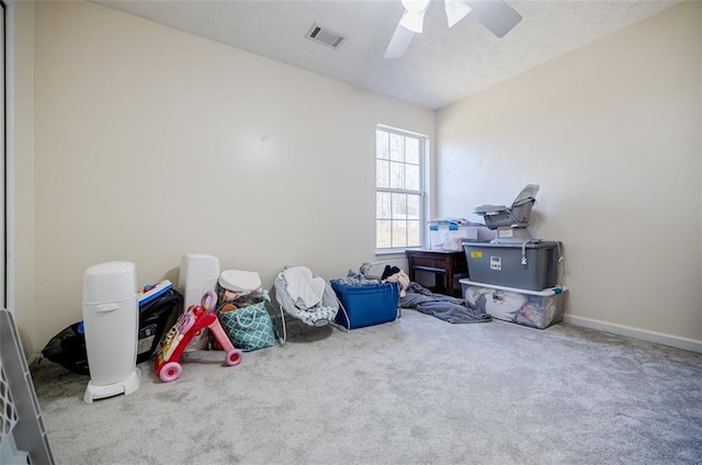 misc room featuring carpet flooring and ceiling fan