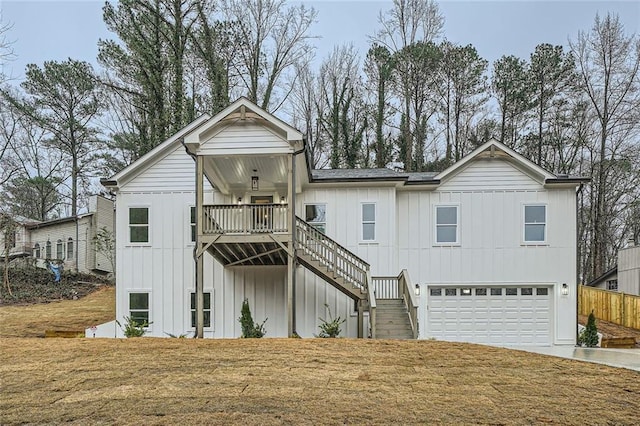 view of front of property featuring driveway, a garage, stairway, a front lawn, and board and batten siding