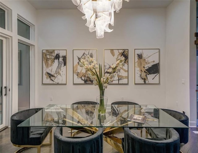 dining area featuring hardwood / wood-style flooring and a notable chandelier