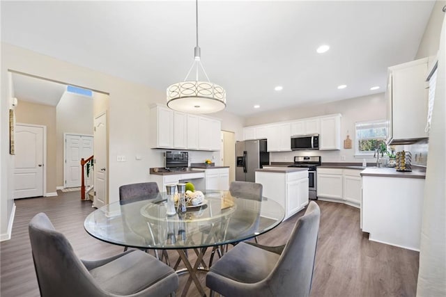 dining space with dark hardwood / wood-style flooring and sink