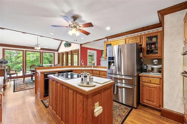 312 Crabapple Springs Way, Woodstock, GA 30188 - kitchen with stainless steel fridge, a peninsula, ornamental molding, ceiling fan, and a kitchen island