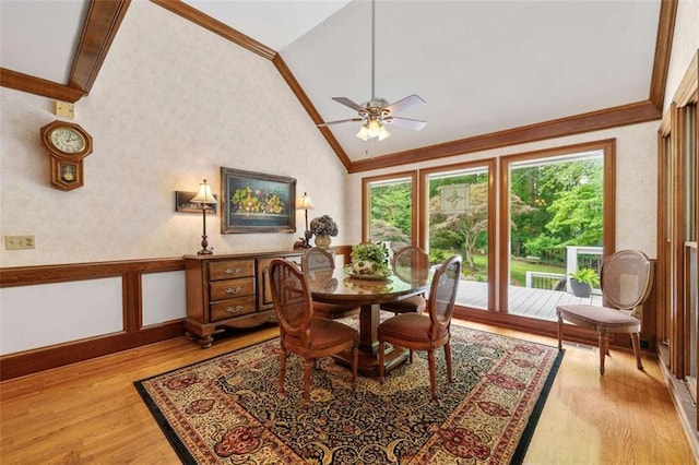 312 Crabapple Springs Way, Woodstock, GA 30188 - dining room with vaulted ceiling, wallpapered walls, light wood finished floors, wainscoting, and a ceiling fan