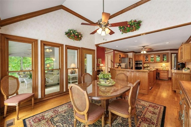 312 Crabapple Springs Way, Woodstock, GA 30188 - dining space with ceiling fan, light wood finished floors, ornamental molding, vaulted ceiling, and wallpapered walls