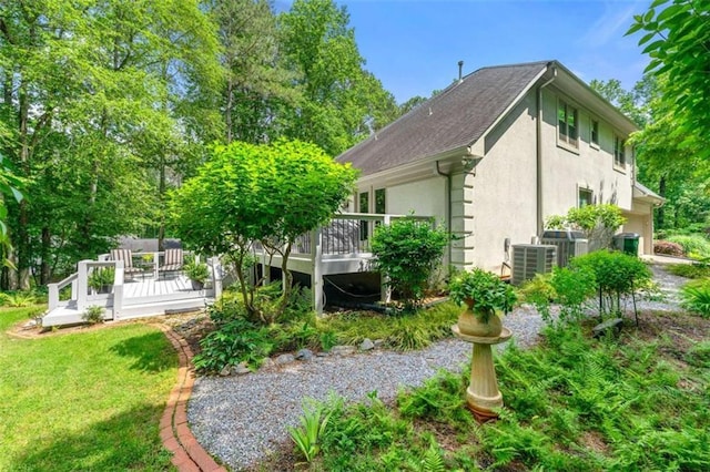 312 Crabapple Springs Way, Woodstock, GA 30188 - view of home's exterior featuring stucco siding, a wooden deck, a yard, and central AC