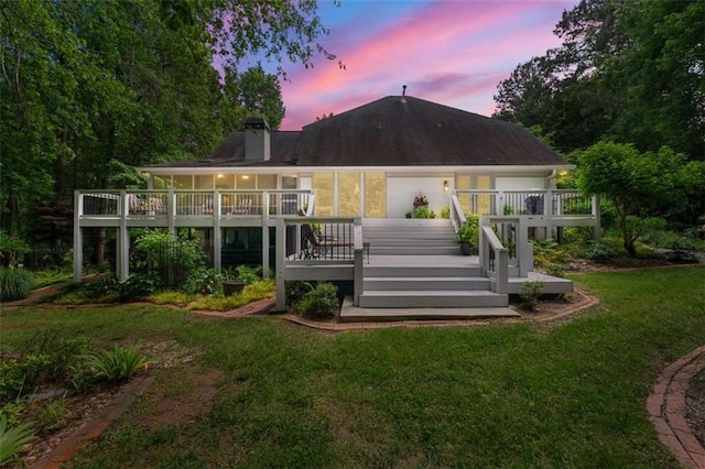312 Crabapple Springs Way, Woodstock, GA 30188 - back of property at dusk with a yard, stairs, a deck, and a chimney
