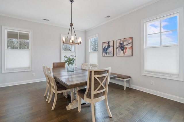 dining space with an inviting chandelier, ornamental molding, dark wood-style floors, and baseboards