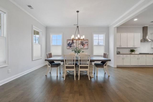 dining space featuring a notable chandelier, dark wood finished floors, baseboards, visible vents, and ornamental molding