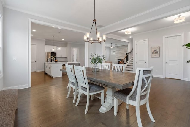 dining area featuring dark wood-style flooring, baseboards, ornamental molding, stairway, and an inviting chandelier