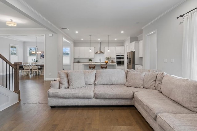 living room featuring recessed lighting, dark wood-style floors, crown molding, and visible vents