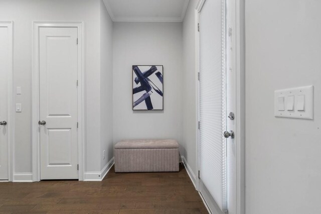 living area with crown molding and light colored carpet