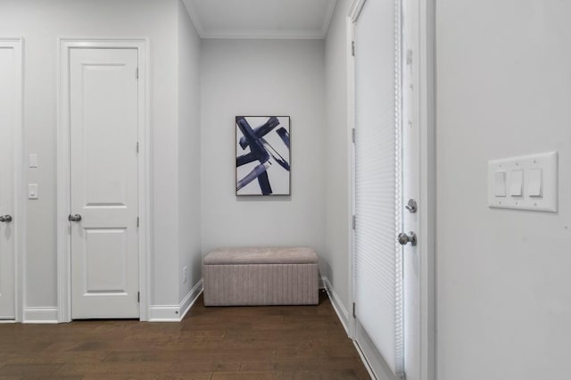 hall featuring baseboards, dark wood-style floors, and crown molding