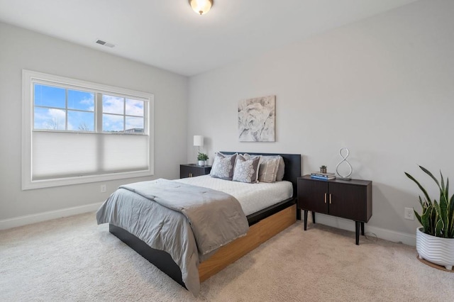 carpeted bedroom featuring baseboards and visible vents