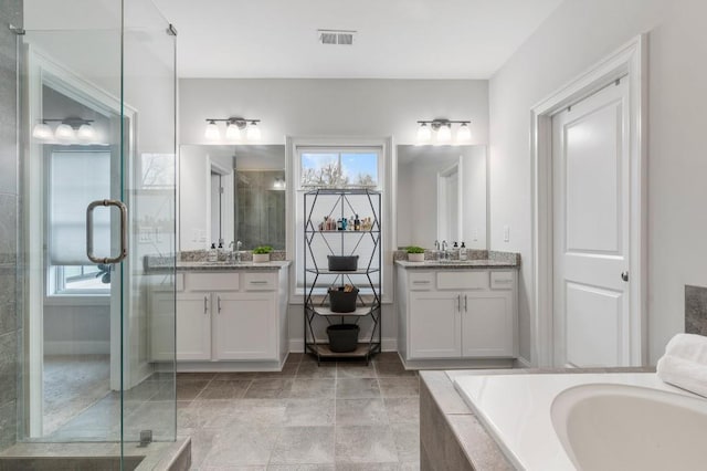 bathroom featuring a sink, a bath, visible vents, and a shower stall