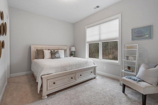 bedroom featuring light carpet, baseboards, and visible vents
