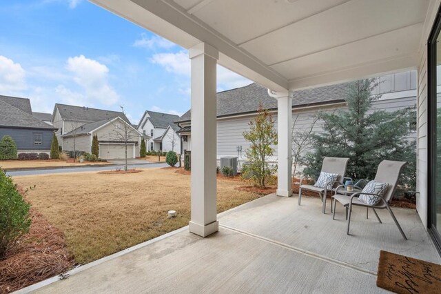 back of house featuring a garage and a yard