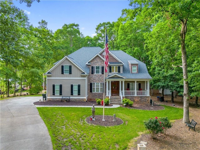 261 Double Springs Rd SW, Monroe, GA 30656 - craftsman house with stone siding, a porch, a front lawn, board and batten siding, and driveway
