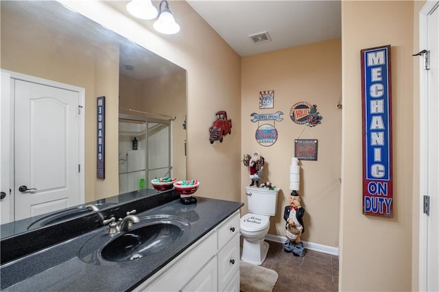 261 Double Springs Rd SW, Monroe, GA 30656 - bathroom with tile patterned floors, vanity, toilet, a shower stall, and baseboards