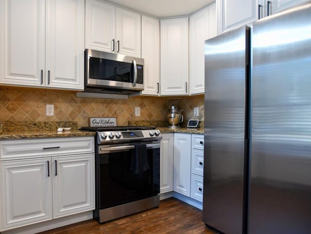 1206 Shiloh Cir NW, Kennesaw, GA 30144 - kitchen with appliances with stainless steel finishes, white cabinetry, dark wood-style flooring, and dark stone countertops