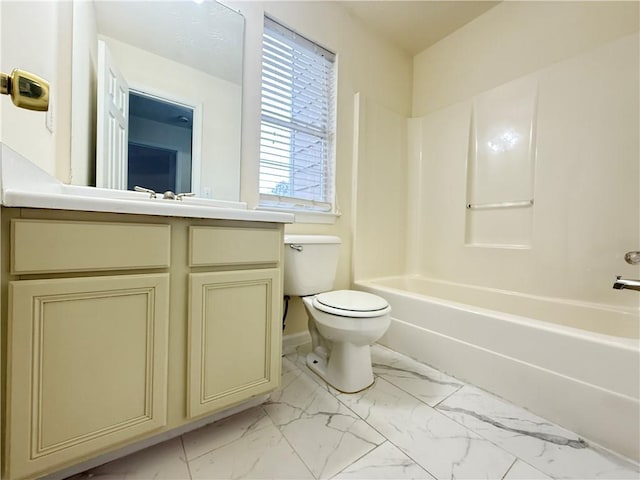 bathroom with toilet, marble finish floor, bathtub / shower combination, and vanity